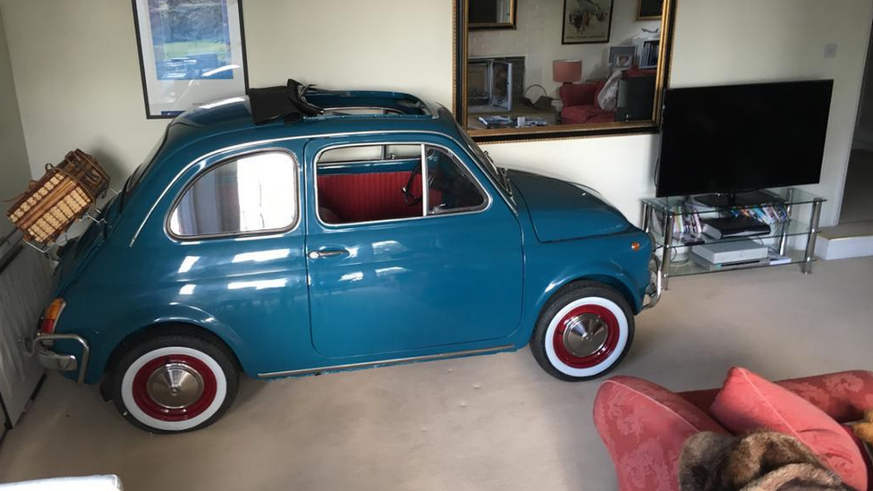 Teal Fiat 500 in the living room