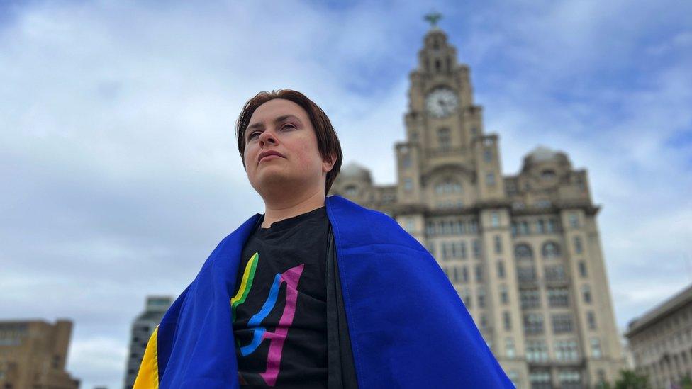 Edward Reese draped in Ukrainian flag outside Liver Building