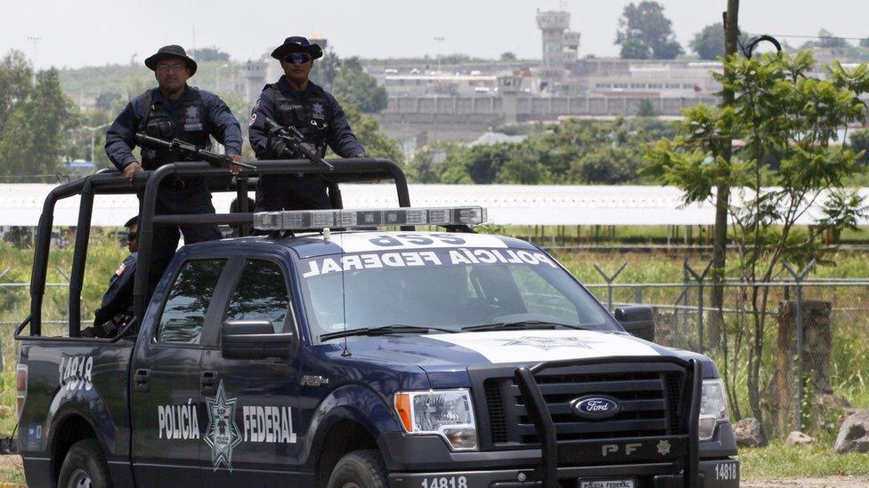 A unit of the Mexican Federal Police patrols the surroundings of the Puente Grande State prison (background) in Zapotlanejo, Jalisco State, Mexico, on 9 August,