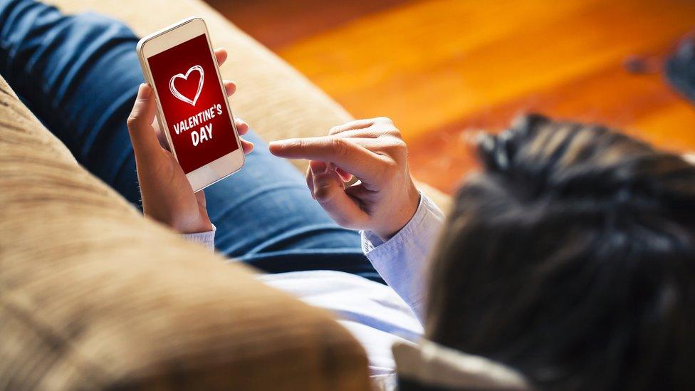 Woman looking at Valentine's Day message on phone