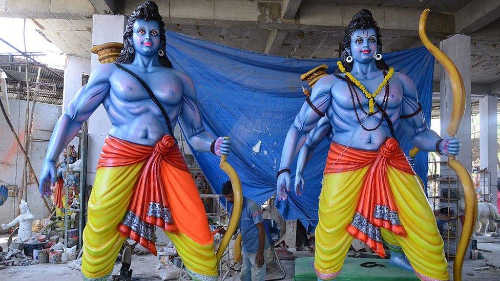 An Indian artist puts final touches to statues of Hindu God Lord Ram in Hyderabad on April 13, 2016