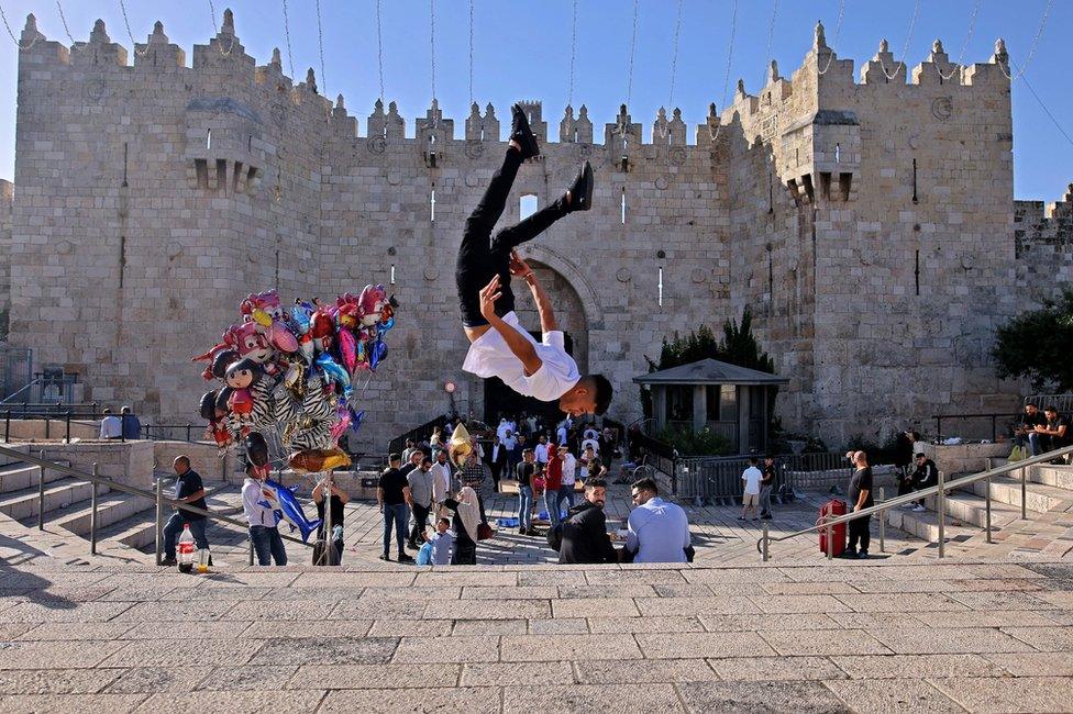 A Palestinian youth performs a jump outside the Damascus Gate in Jerusalem's Old City