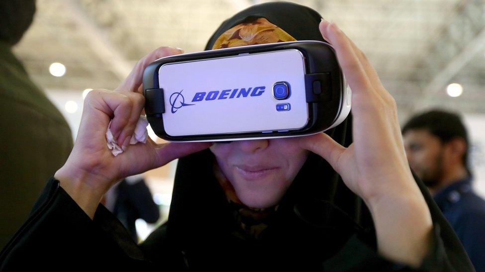 A woman uses Boeing 3-D virtual reality goggles to look at the latest designs of Boeing planes at the Dubai Airshow on 9 Nov, 2015