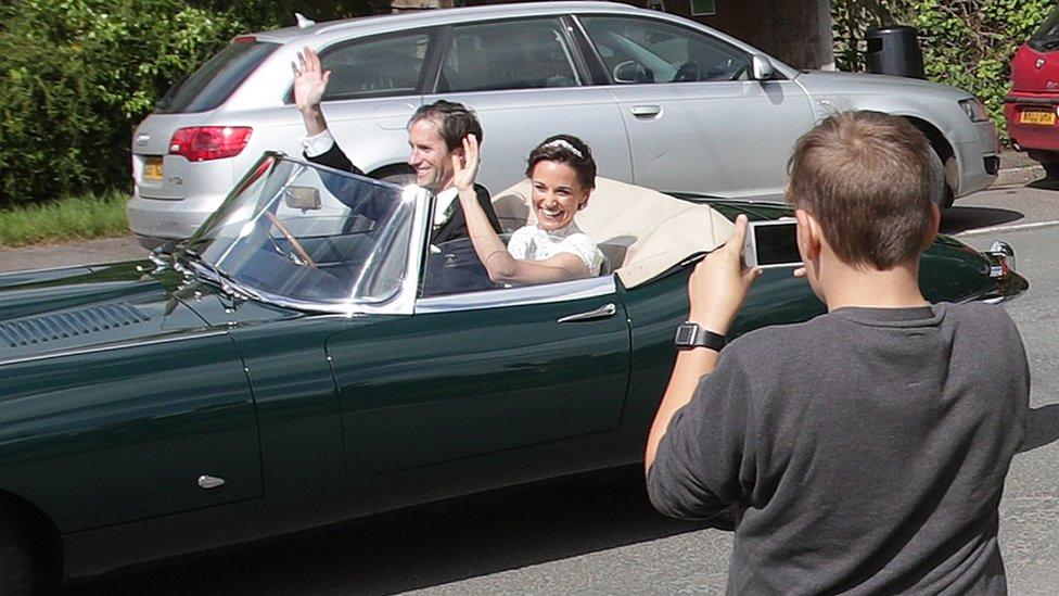 Pippa Middleton and James Matthews wave as they drive a Jaguar E-Type after their wedding