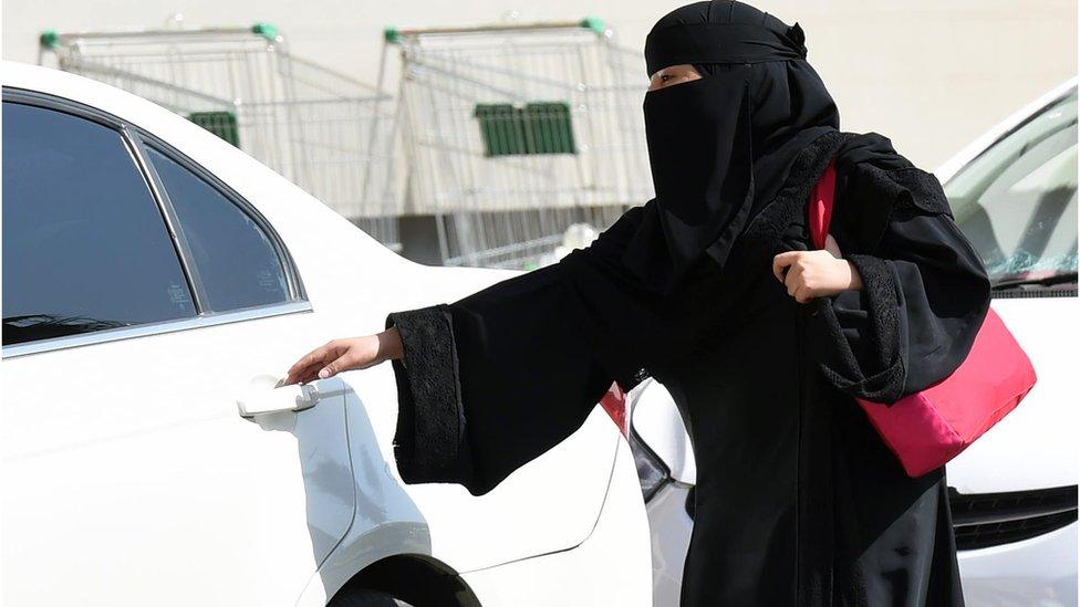 2014 file image of a Saudi woman wearing a niqab getting into a taxi at a mall in Riyadh