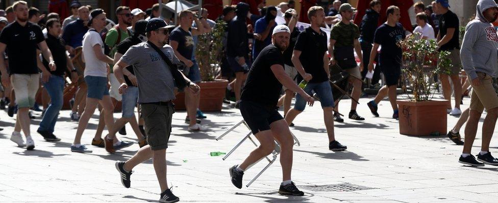 Russian fans run at England fans as they clash ahead of the game against Russia on June 11, 2016 in Marseille