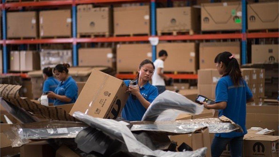 Chinese workers packing goods at a warehouse in the Shanghai Pilot Free Trade zone