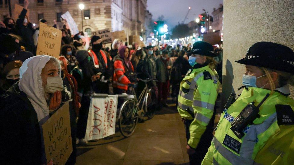 Protesters face police officers who stand in front of the Winston Churchill statue in Parliament Square