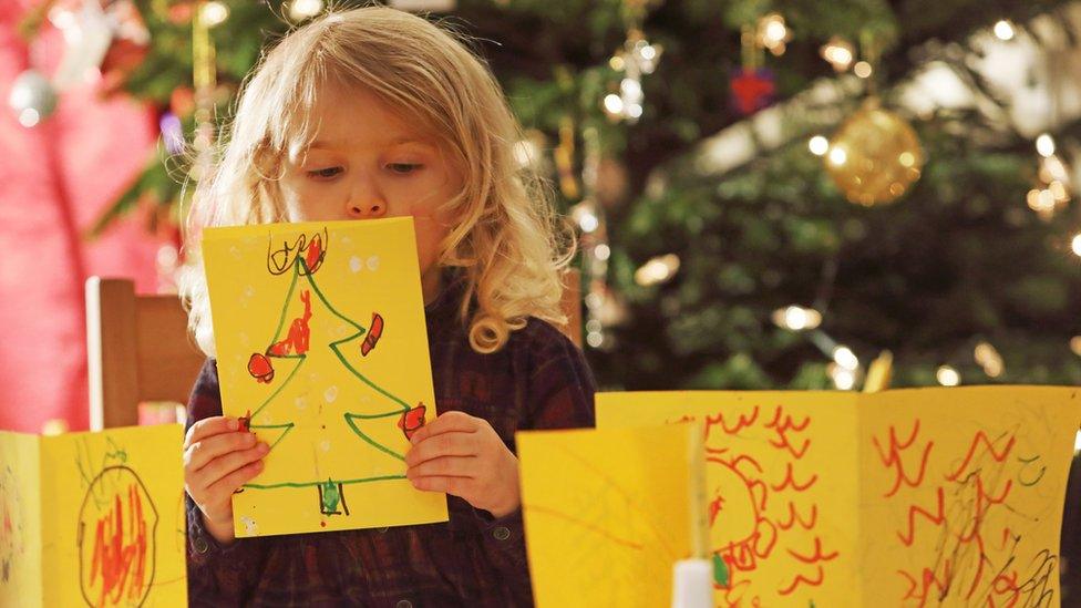 Child making Christmas cards