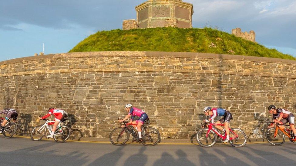 A group of cyclists travelling around Castle Point in Aberystwyth