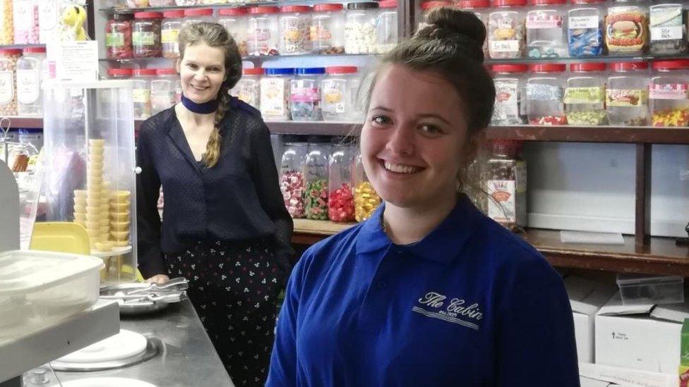 Behind the counter at the ice cream shop