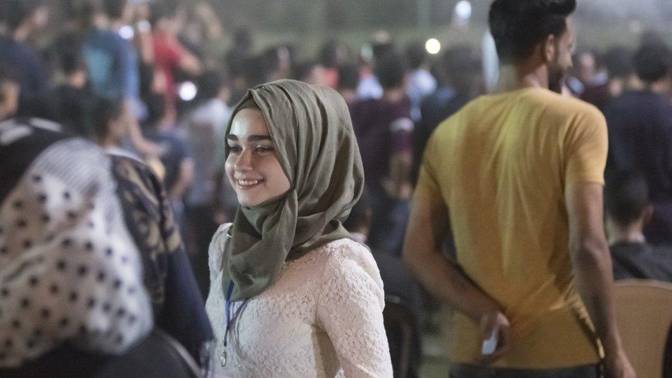 Woman smiles at Mosul Peace Festival (Sept 2017)