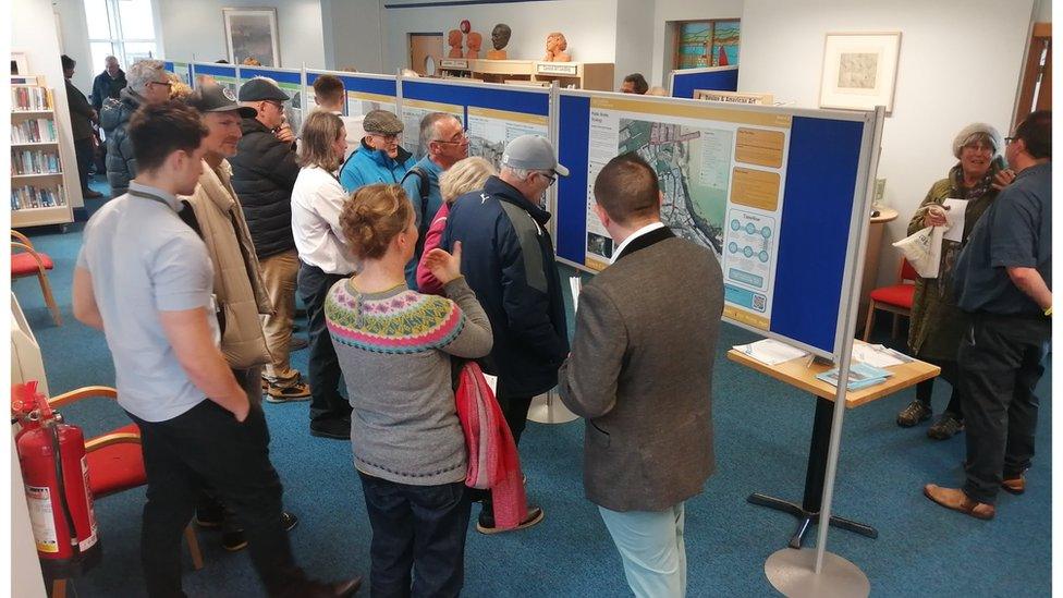 People at St Ives library gathered around the plans