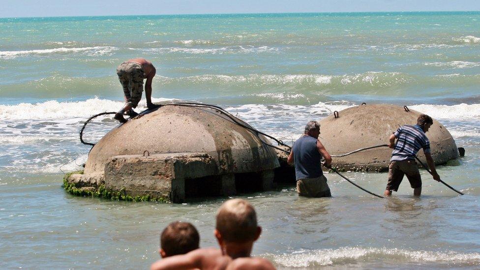 Bunkers on a beach being removed