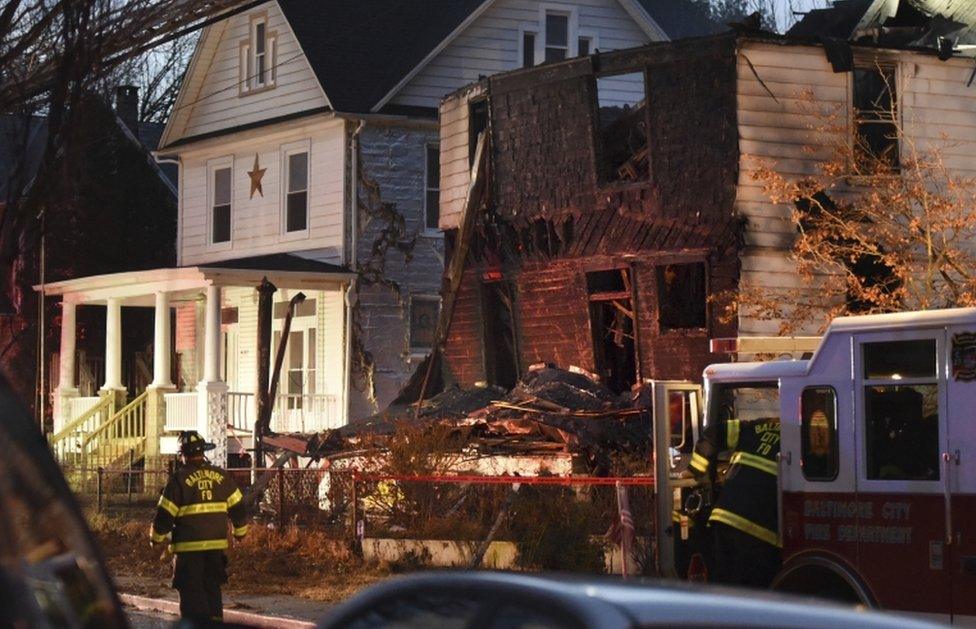 Baltimore City firefighters after a fire on Springwood Avenue in northeast Baltimore on 12 January 2017.