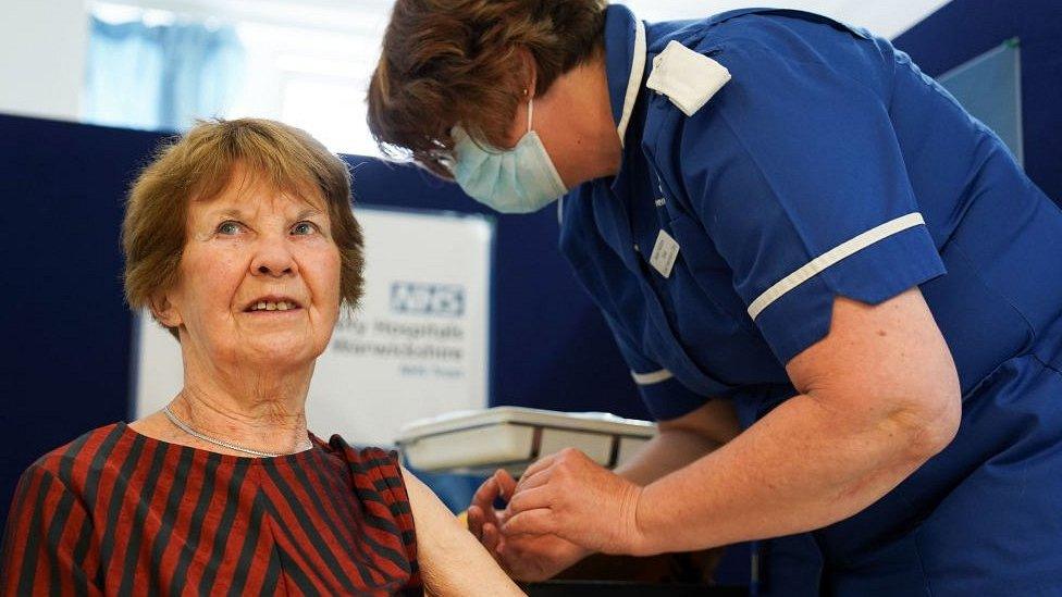 Margaret Keenan being given a vaccine by a nurse