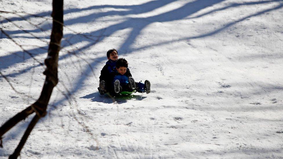 Children play in the snow