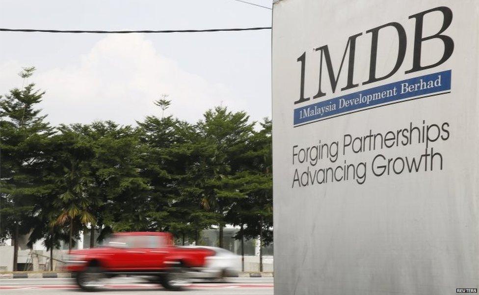 Traffic passes a 1Malaysia Development Berhad (1MDB) billboard at the Tun Razak Exchange development in Kuala Lumpur, Malaysia, 6 July 2015