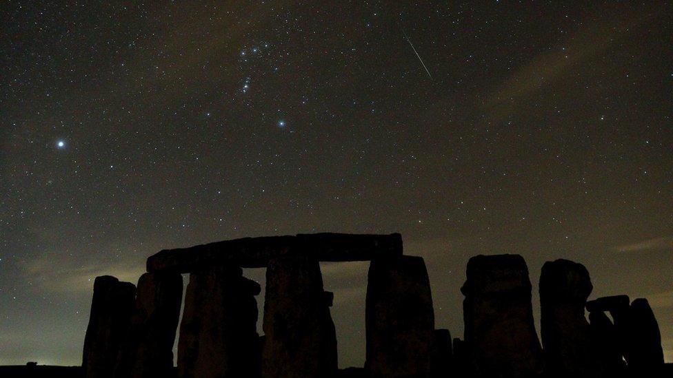 Geminid meteor shower seen in the night sky above Stonehenge