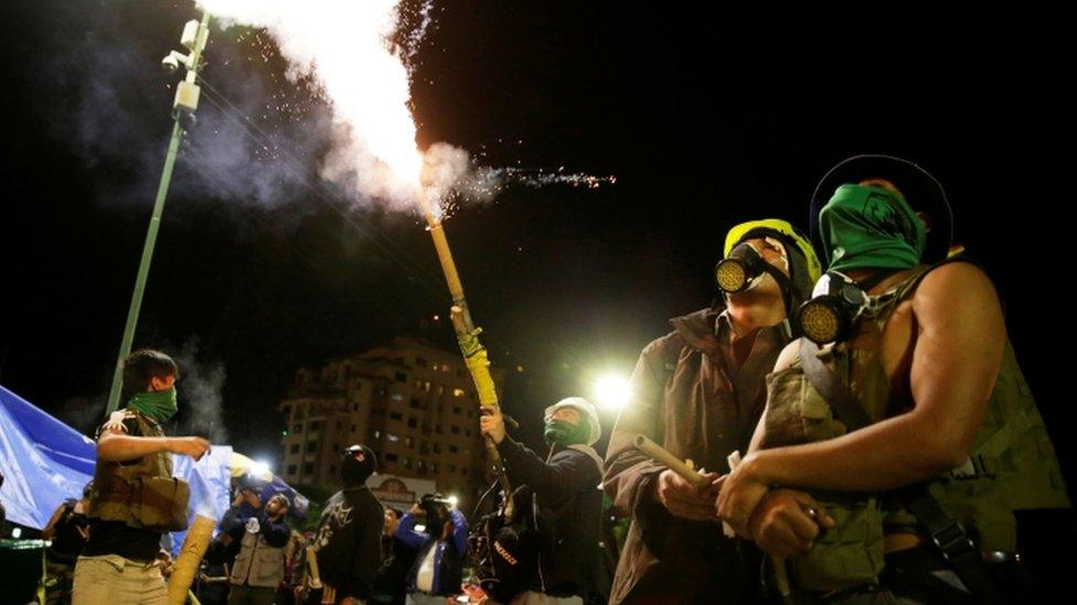 Members of the youth resistance setting off fireworks