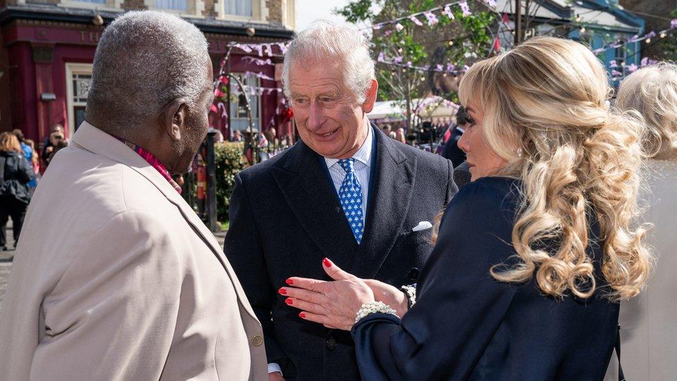 King Charles III, then Prince of Wales, speaking to EastEnders actors Letitia Dean and Rudolph Walker during a visit in march this year