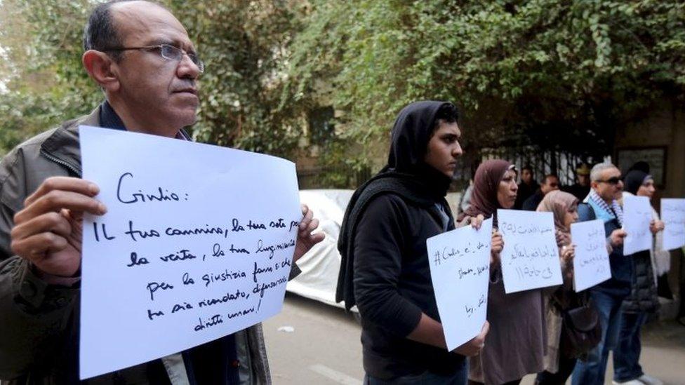 Activists hold placards, which read, among others, "Giulio, one of us and killed like us", during a memorial for Italian Giulio Regeni outside the Italian embassy in Cairo (24 March 2016)