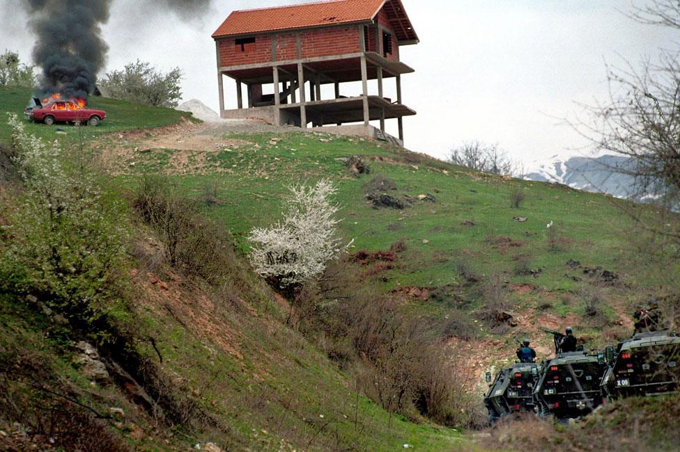 Macedonian armoured personnel carriers armed with heavy machine guns attack Gajre March 25, 2001 in the hills above Tetovo as Macedonian forces launched an offensive against the village to rout out Albanian rebels