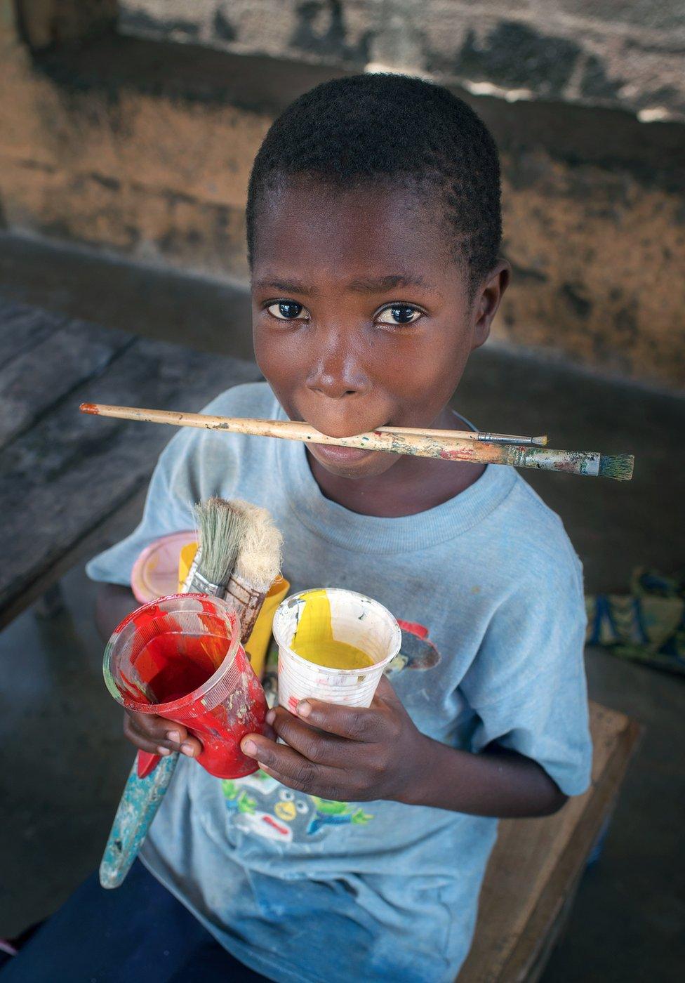 Louis Houenoude's son with a brush and cups