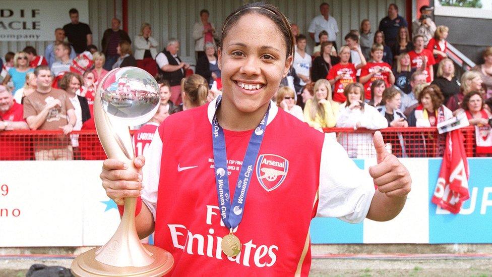 Alex-Scott-poses-for-the-camera-holding-the-UEFA-womens-super-league-trophy-in-her-arsenal-kit