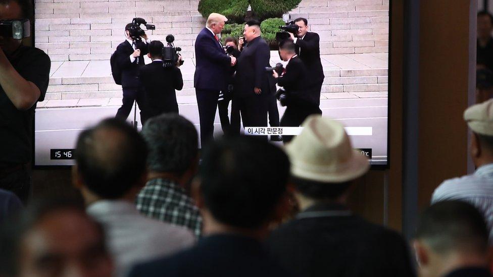 People watch the meeting in South Korea