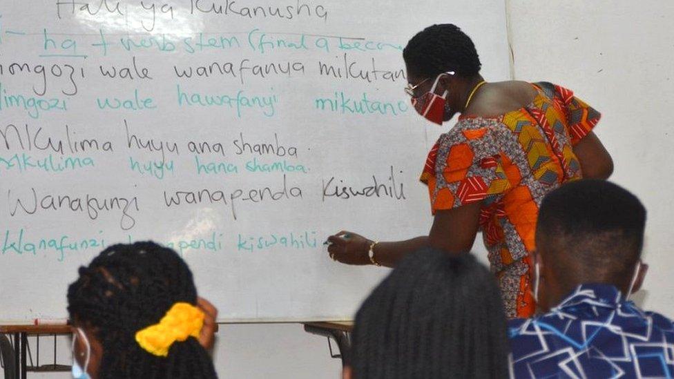 Teacher at a white board