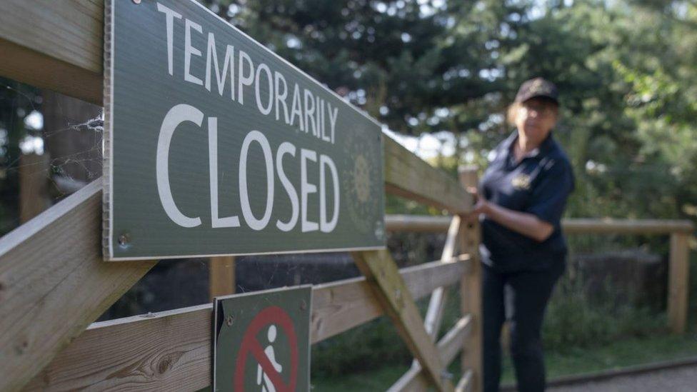 Wooden gate with temporary closure sign