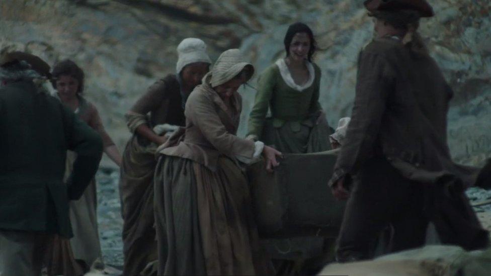 People scavenging food off a beach