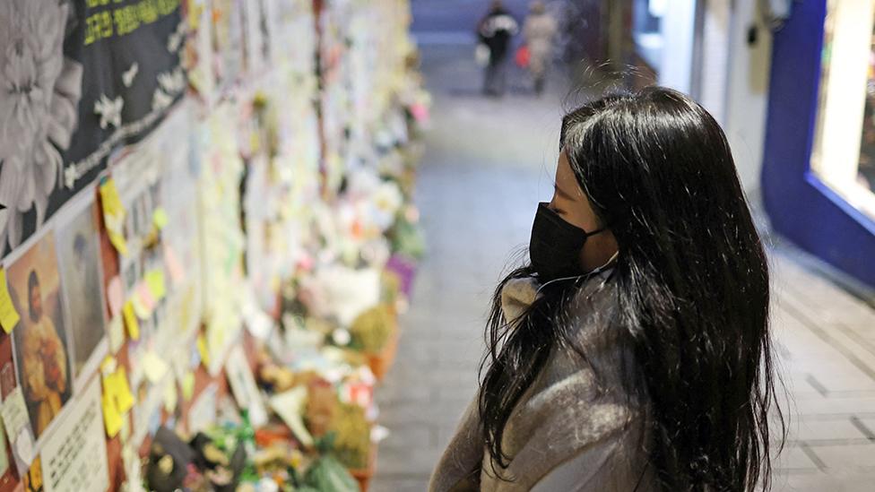 woman reads condolence messages