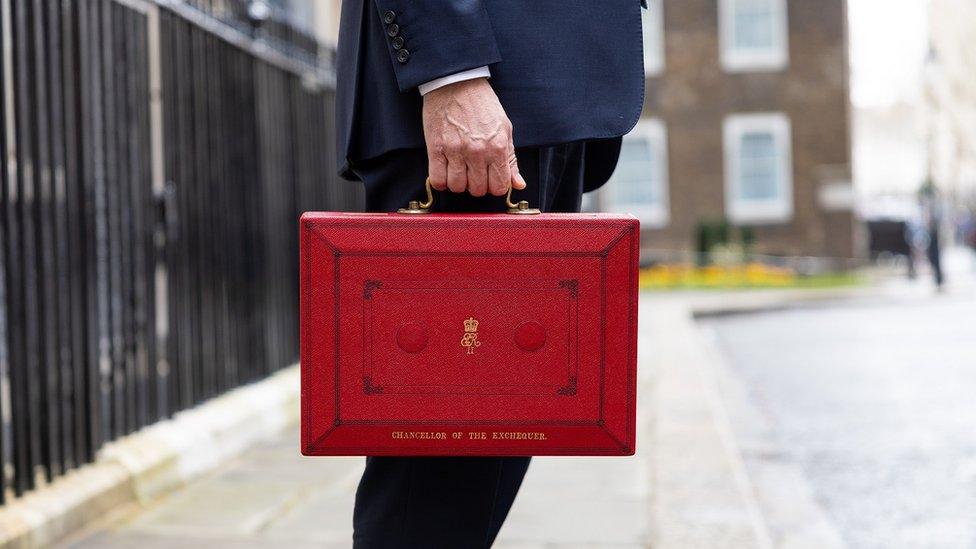 man-holding-red-briefcase.