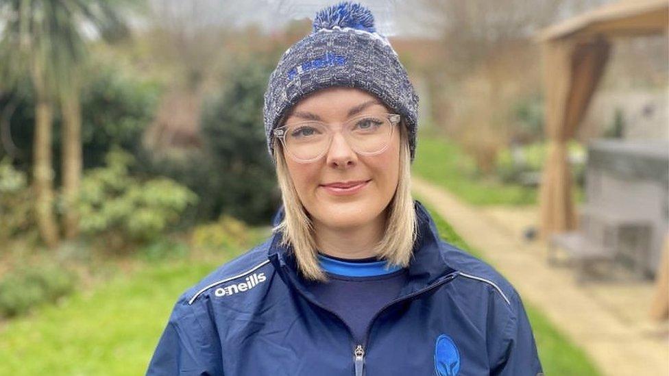 A woman wearing a hat in a garden