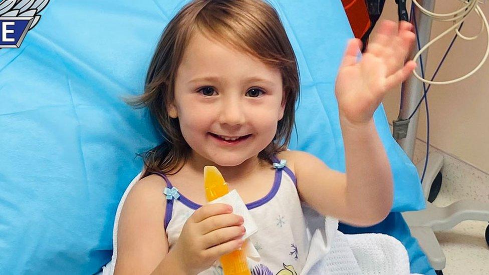 Cleo Smith waves from a hospital bed after her rescue