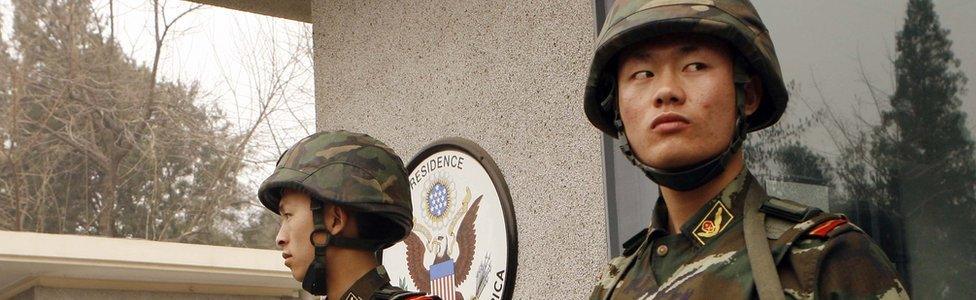 Three armed Chinese policemen guarding the US embassy in Beijing