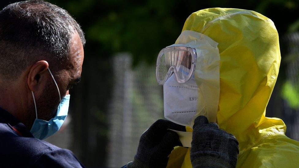 Firefighters prepare before disinfecting a nursing home for elderly people where more than 60 people tested positive for Covid-19 in Burbaguena, near Teruel on 4 August 2020