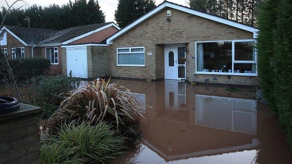 Flood water around a house in Lowdham