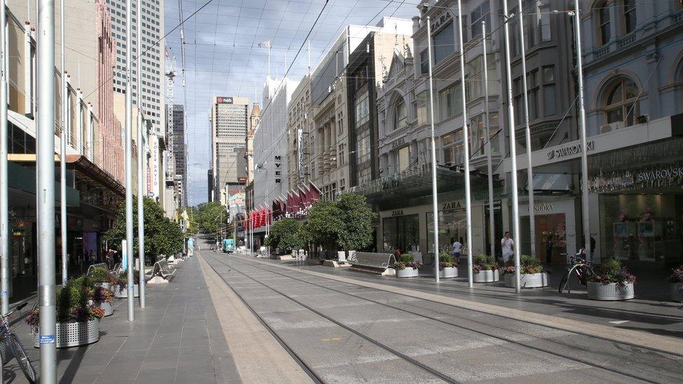 A nearly deserted shopping strip Bourke Street Mall in Melbourne