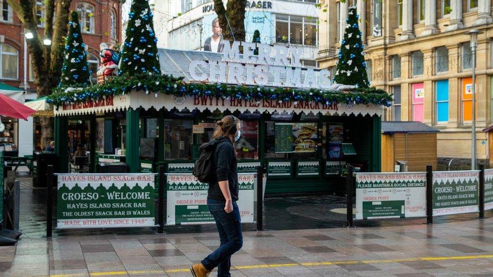 A man passes a festively decorated Hayes Island Snack Bar in Cardiff city centre