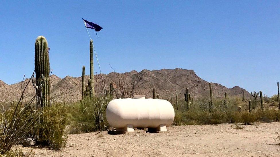 Humanitarian water supplies for border crossers are marked by purple flags