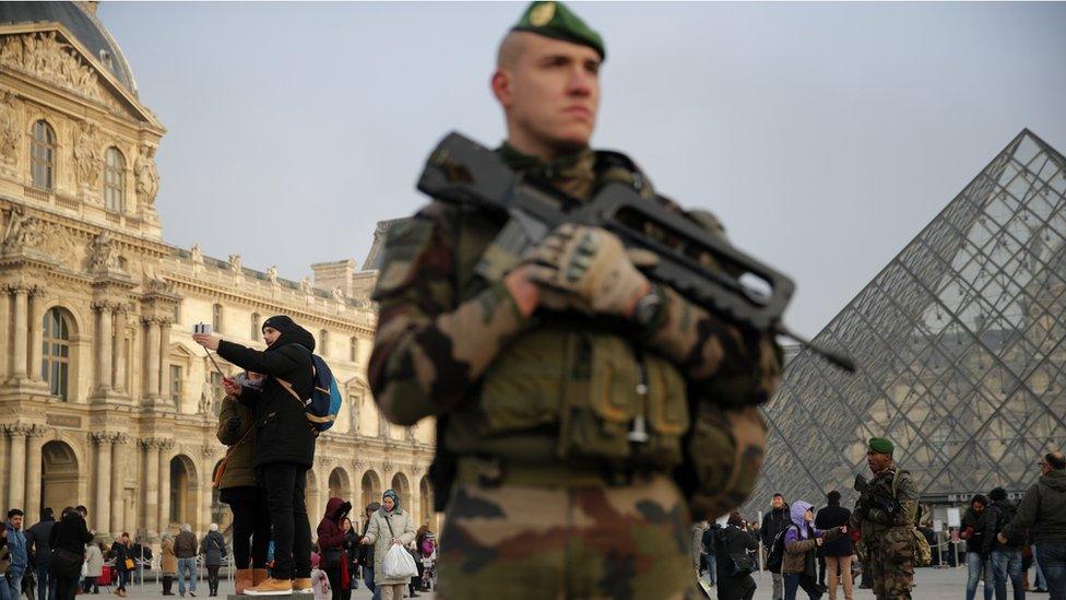 A soldier guarding The Louvre in Paris