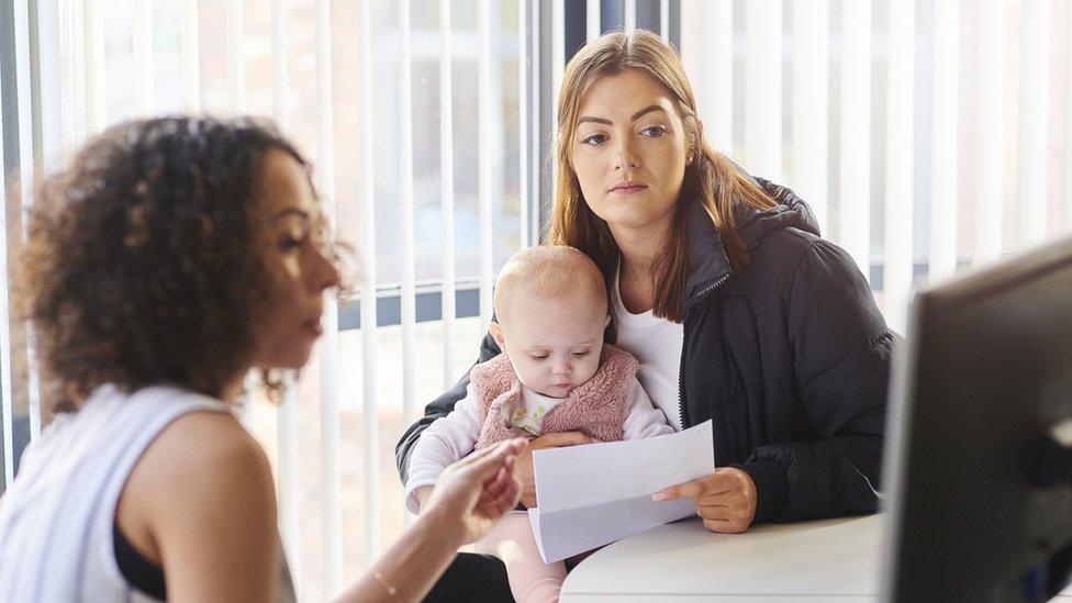 Woman and baby with a benefits officer