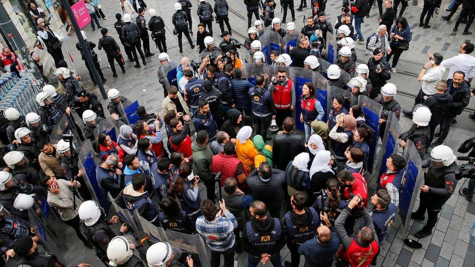 Supporters of pro-Kurdish Peoples' Democratic Party (HDP) are surrounded by riot police as they try to march during a protest in Istanbul