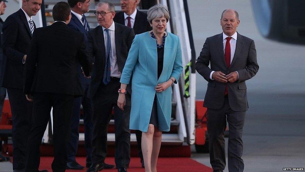 Theresa May greeted by Olaf Scholz, the mayor of Hamburg, as she arrives in the city for the G20 summit