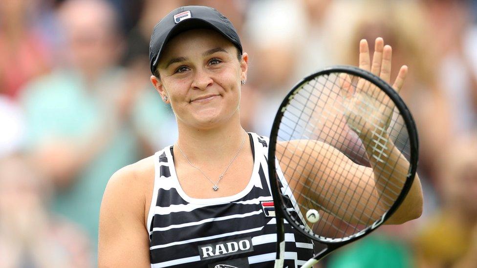 Ashleigh Barty smiles on court and claps with her racquet at Birmingham