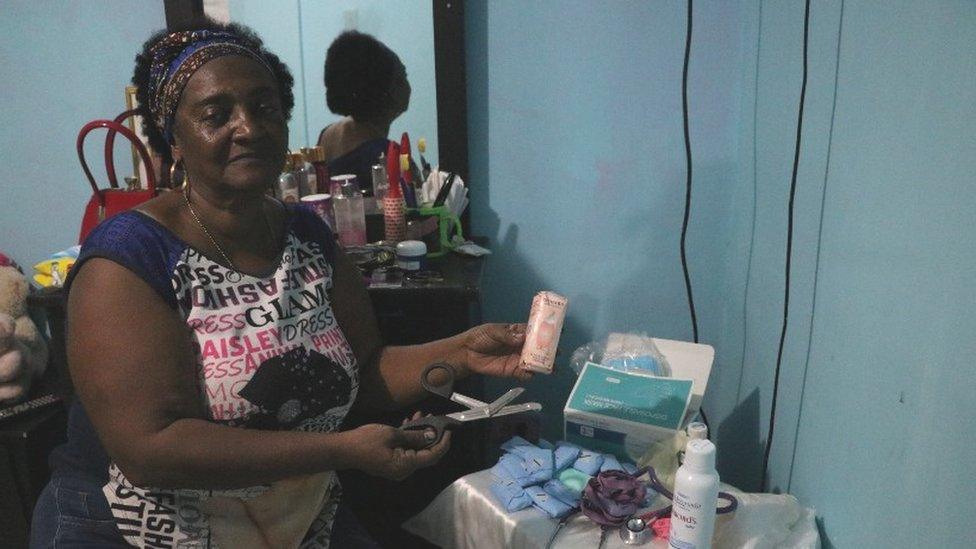 Feliciana Hurtado poses for a photo in her Buenaventura home