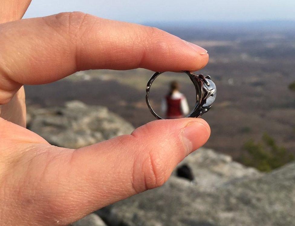 A close up of the ring, with Meg in the far distance seen through the middle of it